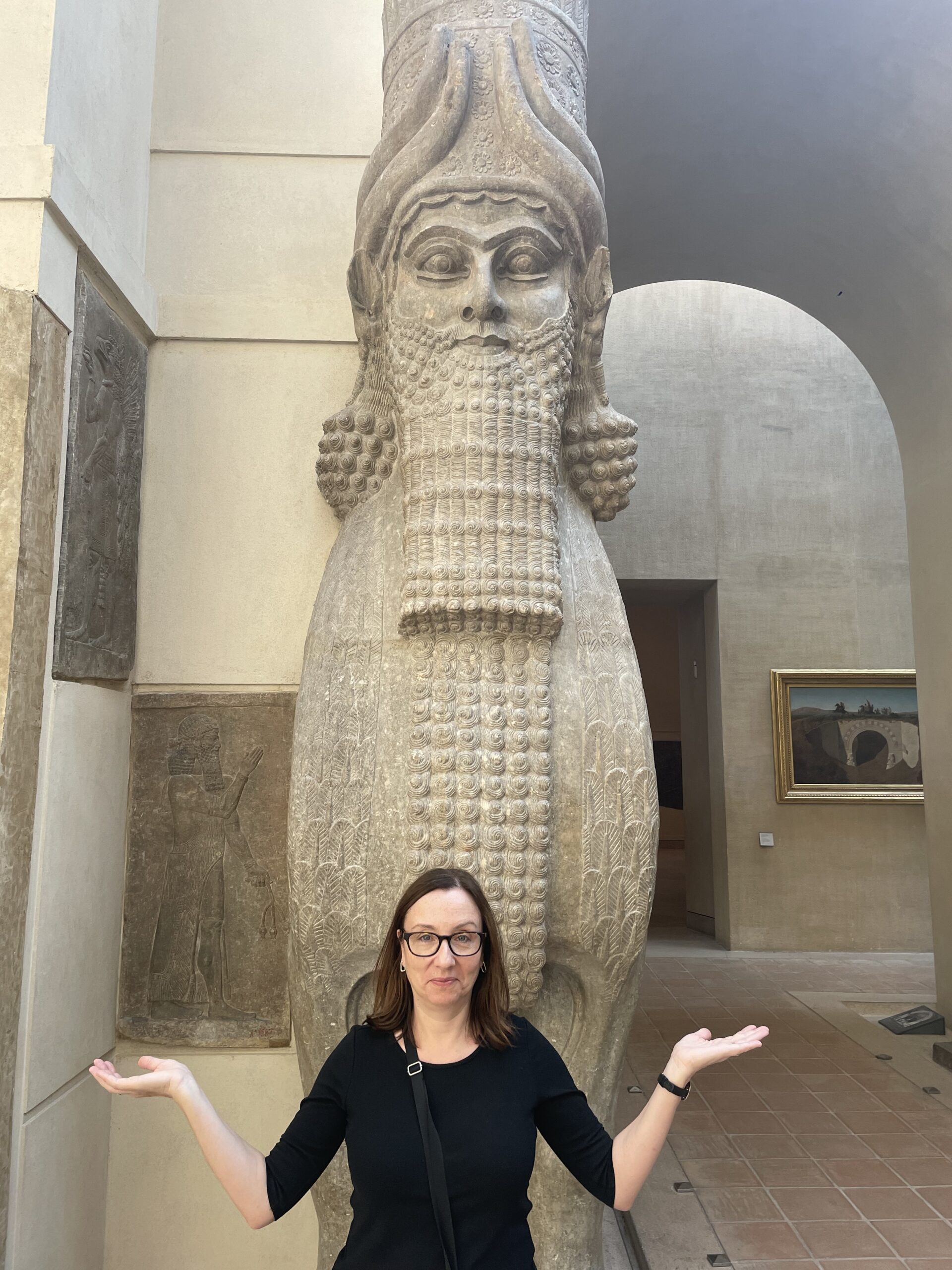 Author with Egyptian statue, hands open